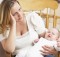 Worried Mother Holding Baby In Nursery