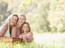 Grandmother with adult daughter and grandchild on picnic