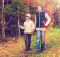 two happy kids walking along forest path